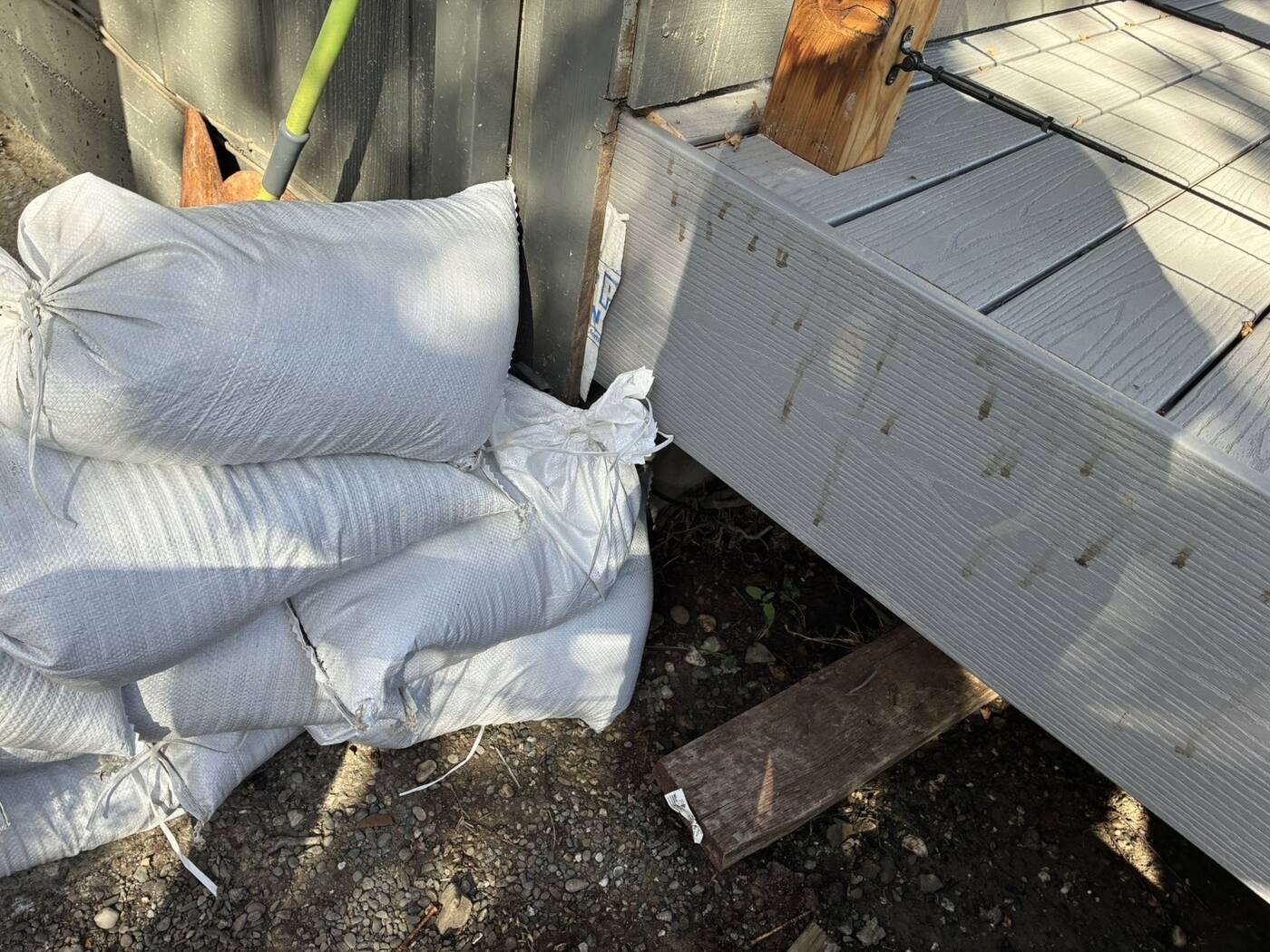 Staggered sandbags at a deck corner
