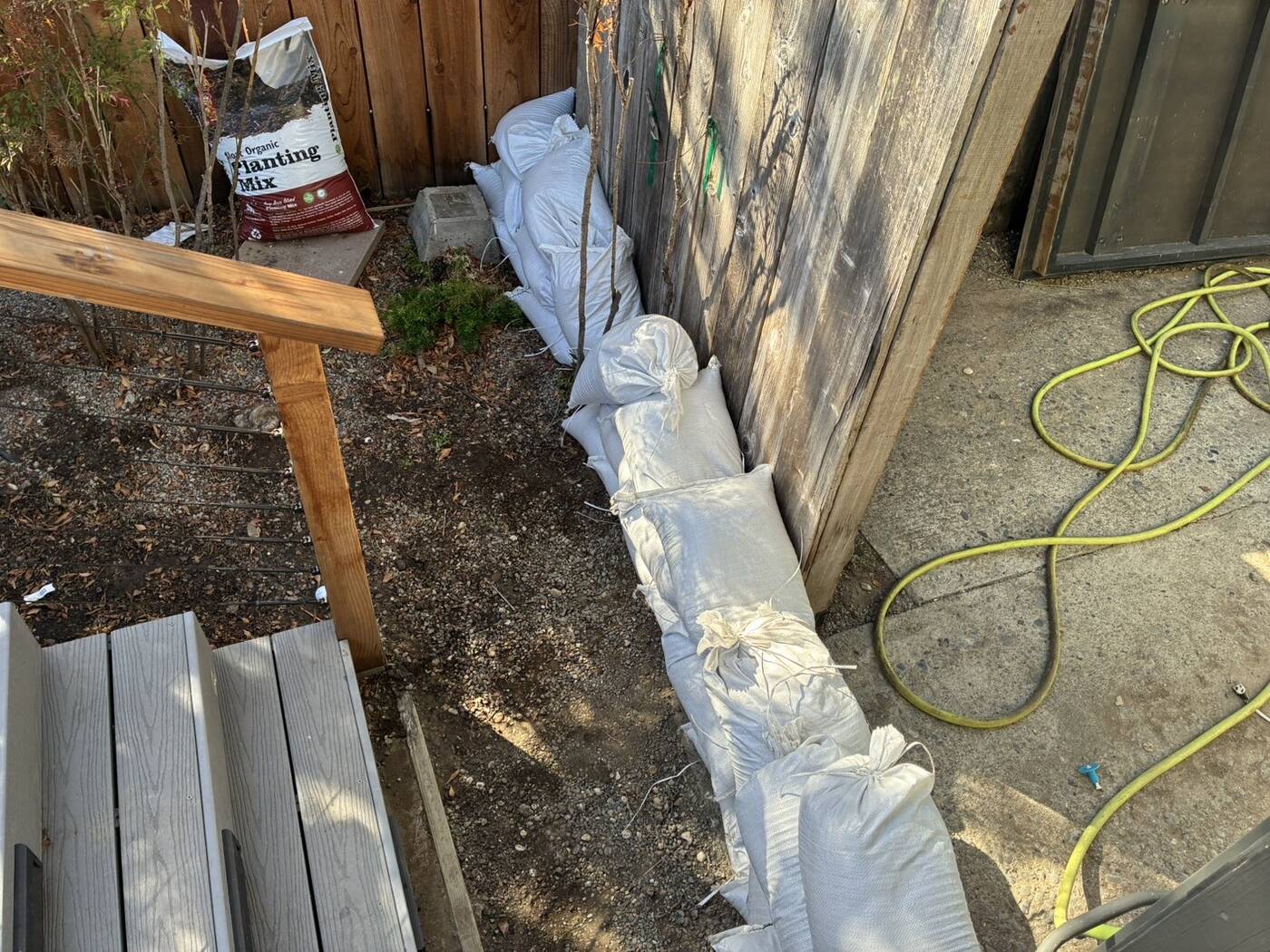 Overhead view of a sandbag line along a fence