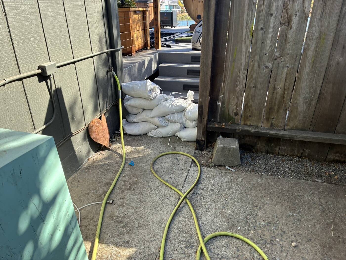 Sandbags across a side gate